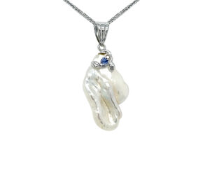 BIWA PEARL AND SAPPHIRE PENDANT 
19MM BIWA PEARL 
SAPPHIRE ACCENT 
18KY 
1.25" APPROX LENGTH