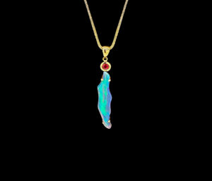 BLACK LIGHTENING RIDGE OPAL AND RUBY PENDANT 
4.82 CT OPAL 
.26 CT RUBY 
14KY 2" LENGTH 
*CHAIN NOT INCLUDED