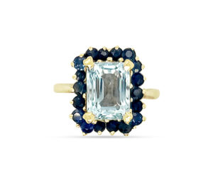 1970'S ESTATE AQUAMARINE AD BLUE SAPPHIRE RING
2.50 CT EMERALD CUT AQUAMARINE
SURROUNDED BY 
1.00 CTTW BLUE SAPPHIRES
14KY SIZEABLE 5
CUSTOM MADE